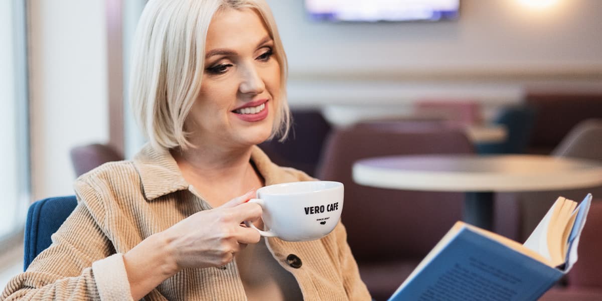 Woman drinks Vero Cafe coffee on DFDS ferry