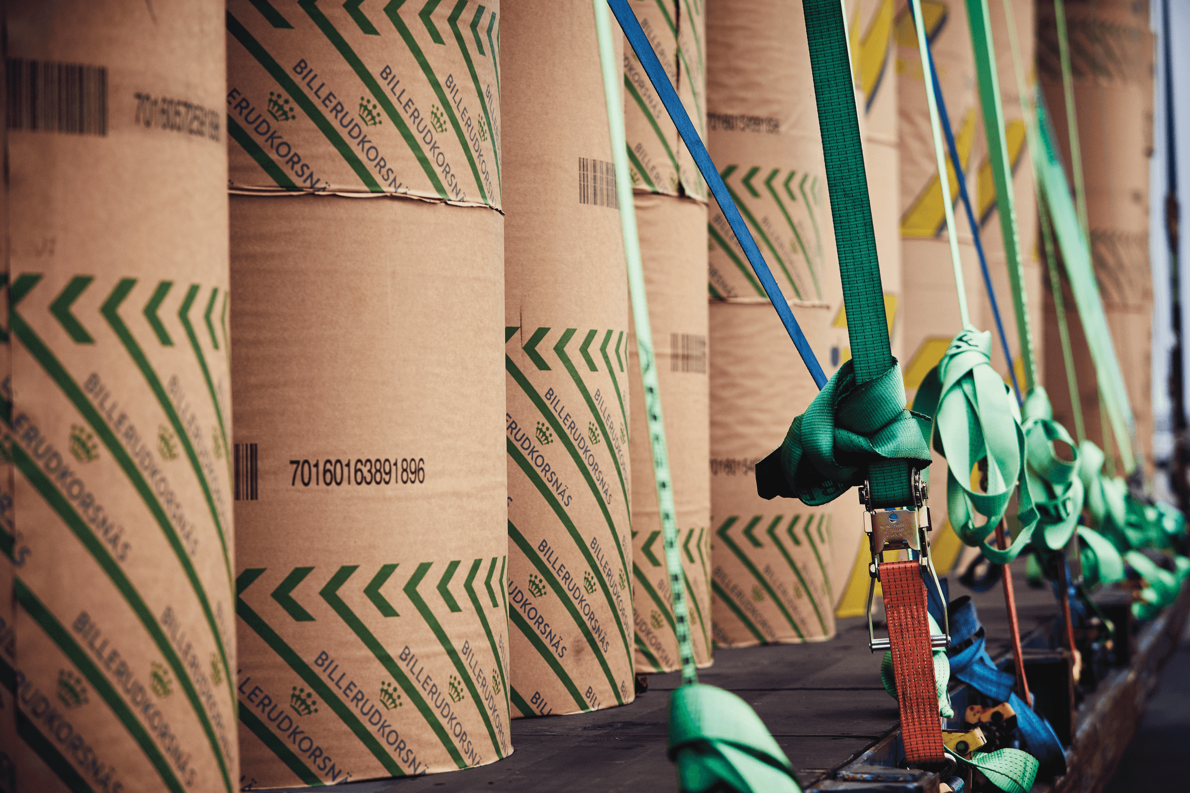 Forest products tied down on a trailer bed, prepared for transport.