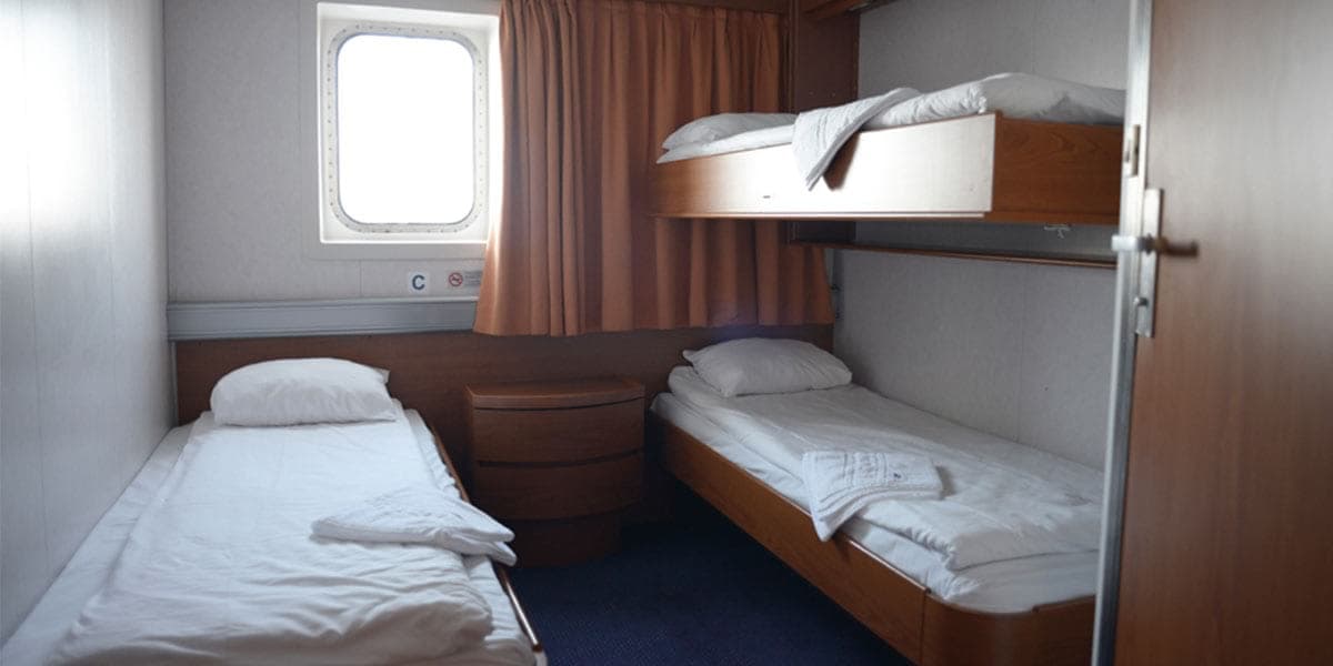 Bunk beds and a single bed in a standard sea view cabin