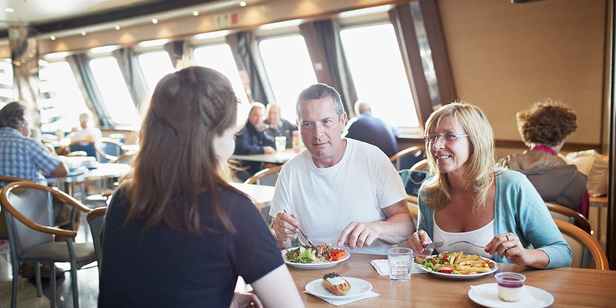 People enjoying food in a restaurant onboard DFDS Newhaven-Dieppe ferry