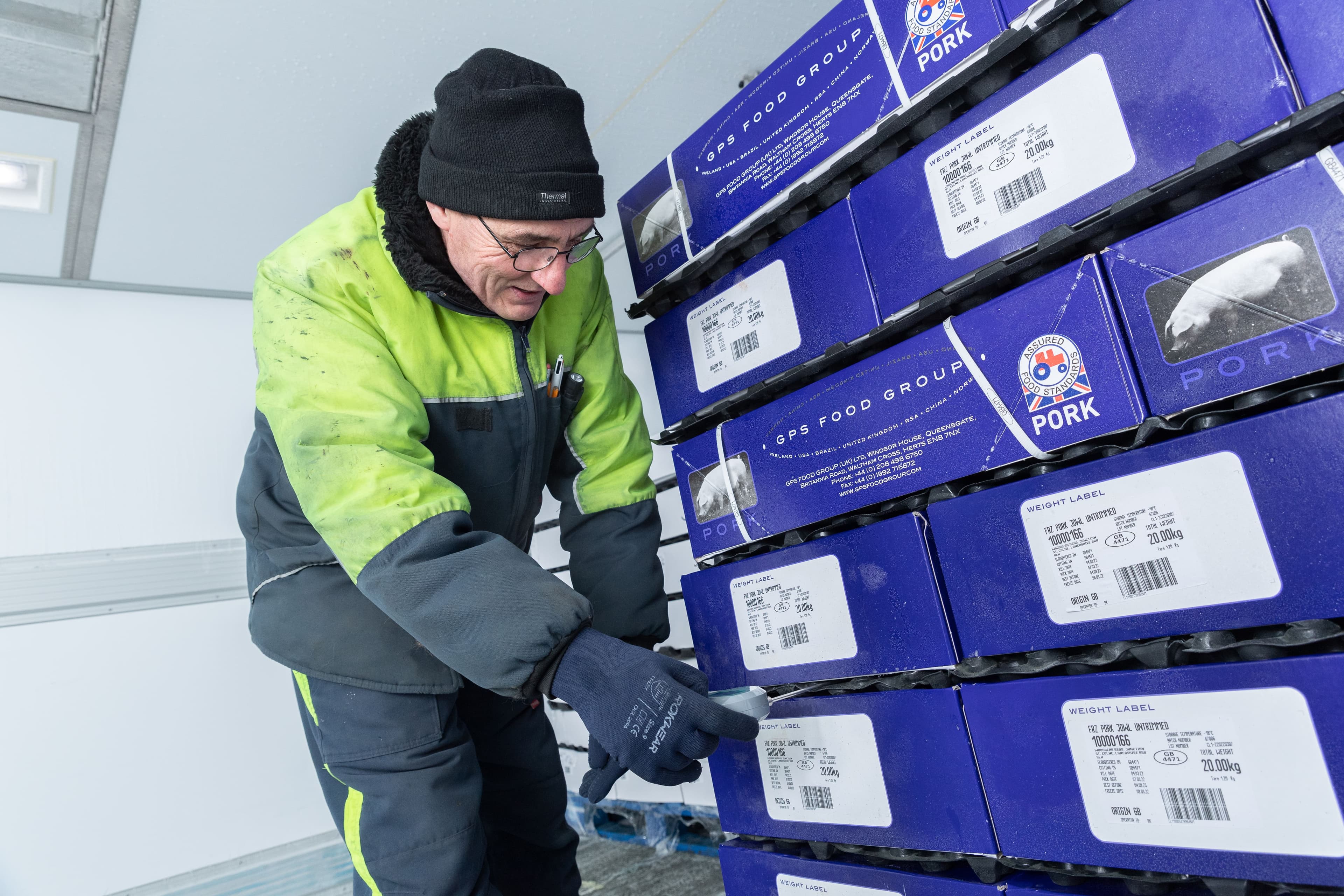 Worker checking the temperature for perishable products.