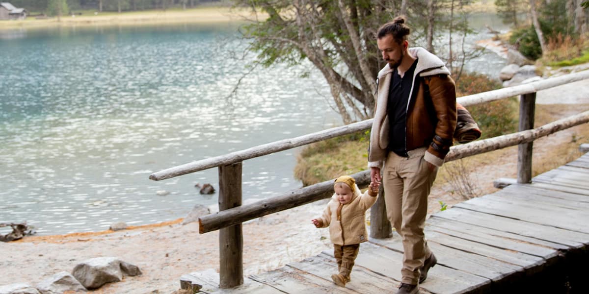 Father & child walk across a bridge