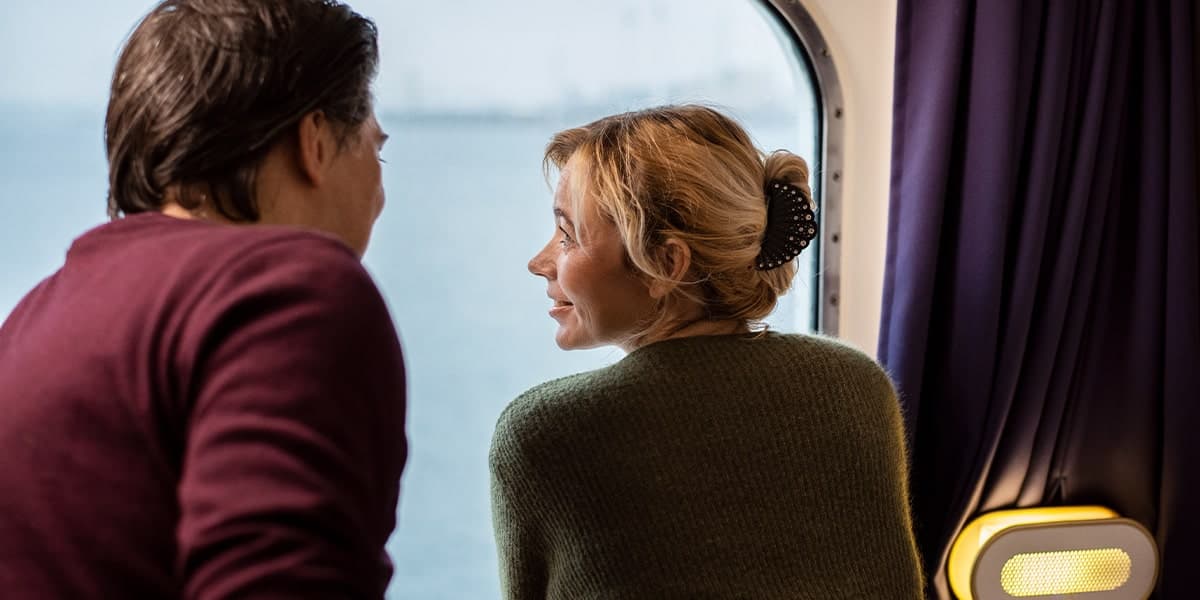Couple looking out of window from cabin