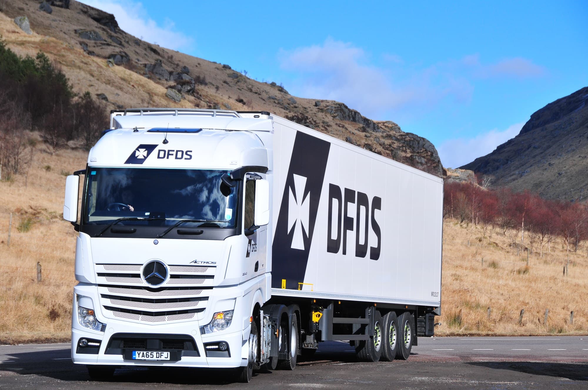 DFDS logistics truck driving through the hills of Lithuania