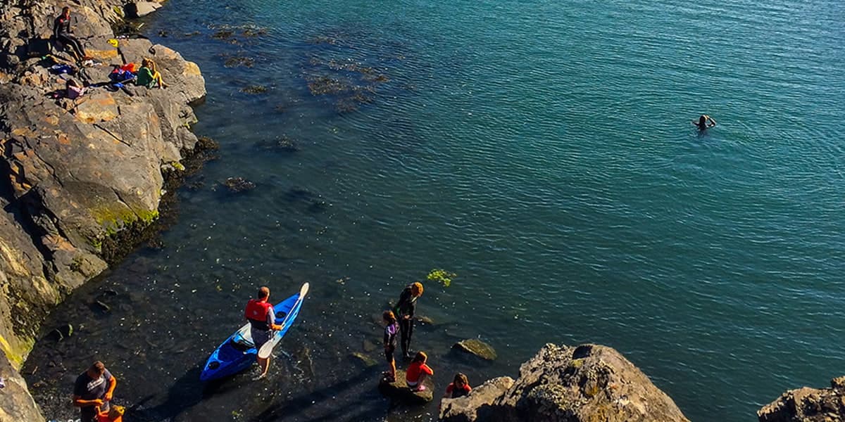 Swimmers and boats on Pembrokeshire coast