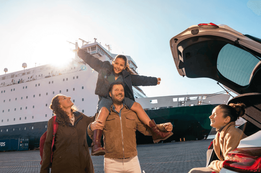 Happy family in front of the ferry