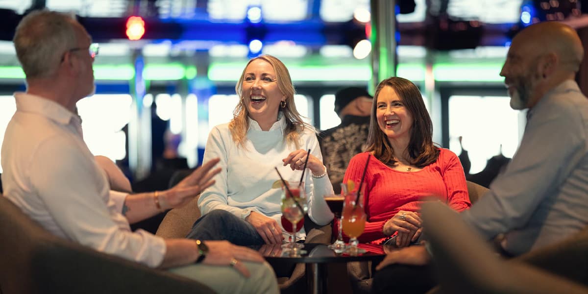 Friends chatting at Navigator's bar on Paldiski-Kapellskar route DFDS