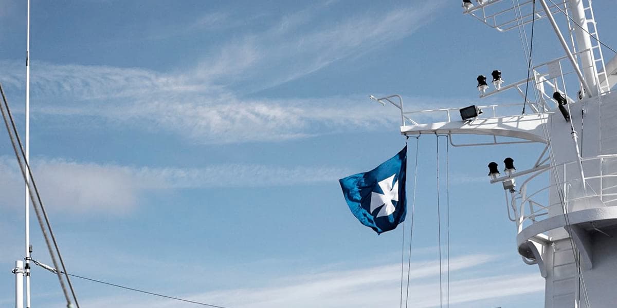A DFDS flag blowing in the wind on one of the ships
