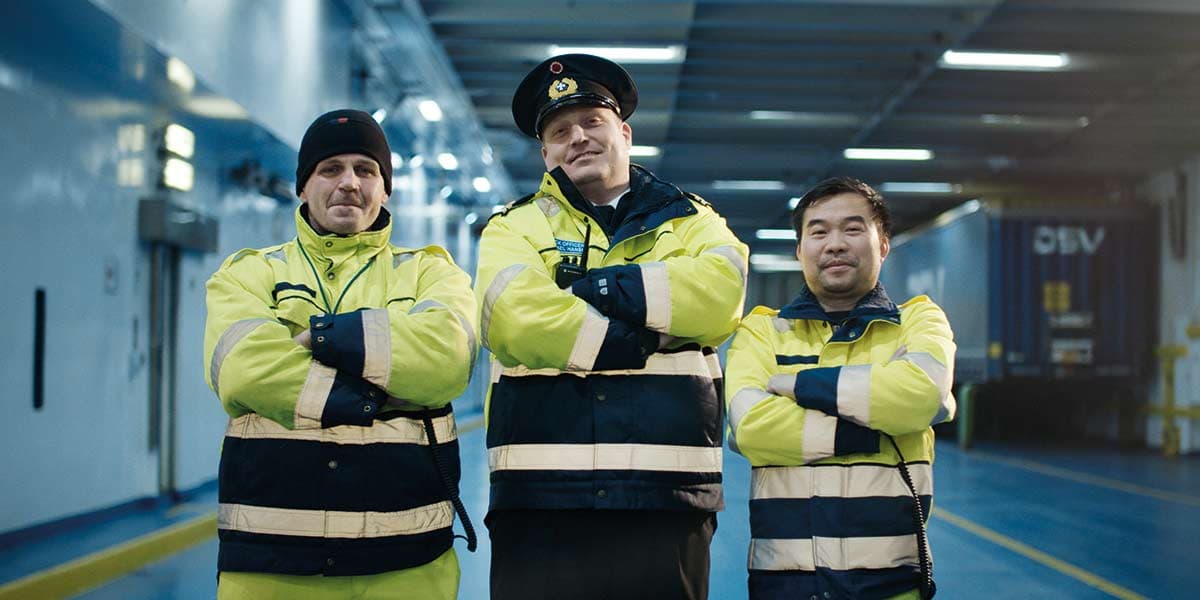 Three DFDS ground staff smiling together